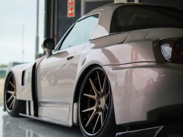 Sleek luxury sports coupe parked indoors, showcasing modern automotive design.